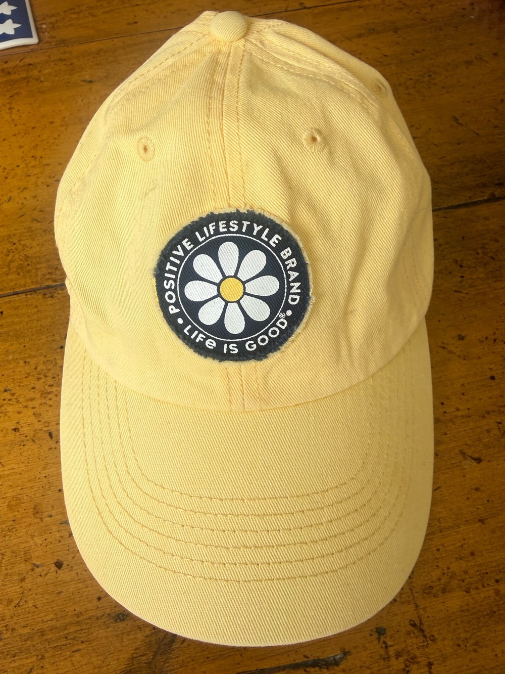 “Life Is Good” Positive lifestyle Brand. Yellow baseball cap with daisy!